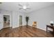 Spacious bedroom with wood floors, ceiling fan, and an ensuite bathroom view at 2344 Pleasant Hill Ln, Holiday, FL 34691