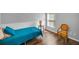 Cozy bedroom features wood-look flooring, natural light, and comfortable furnishings at 2344 Pleasant Hill Ln, Holiday, FL 34691