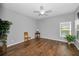 Well-lit bedroom with wood floors, a ceiling fan, and large windows that provide a bright and airy feel at 2344 Pleasant Hill Ln, Holiday, FL 34691