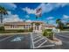 Community clubhouse featuring well-kept landscaping and ample parking at 2344 Pleasant Hill Ln, Holiday, FL 34691