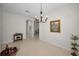 Open dining room showcases an elegant chandelier and leads to other rooms at 2344 Pleasant Hill Ln, Holiday, FL 34691