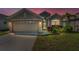 Charming single-story home with a two-car garage and beautifully landscaped front yard at 2344 Pleasant Hill Ln, Holiday, FL 34691
