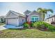 Well-maintained home with attractive landscaping, a two-car garage, and inviting curb appeal at 2344 Pleasant Hill Ln, Holiday, FL 34691