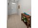 Inviting home foyer with tile flooring and a decorative console table at 2344 Pleasant Hill Ln, Holiday, FL 34691