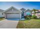 Charming home featuring a well-manicured lawn, front garden, and a two-car garage at 2344 Pleasant Hill Ln, Holiday, FL 34691