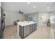 Spacious kitchen featuring a center island with gray cabinets, white countertops, and stainless steel appliances at 2344 Pleasant Hill Ln, Holiday, FL 34691