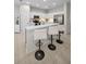 Kitchen featuring white cabinets, stainless appliances, and a breakfast bar with seating at 2344 Pleasant Hill Ln, Holiday, FL 34691