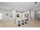 Kitchen bar features white cabinets, stainless steel appliances, and seating for three at 2344 Pleasant Hill Ln, Holiday, FL 34691