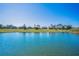 Scenic lake view showcasing waterfront properties with well-maintained lawns at 2344 Pleasant Hill Ln, Holiday, FL 34691