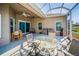 Screened lanai featuring outdoor seating and dining at 2344 Pleasant Hill Ln, Holiday, FL 34691