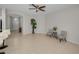 Open living space with tile flooring, a ceiling fan, and a view of the entryway at 2344 Pleasant Hill Ln, Holiday, FL 34691