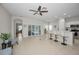 Open-concept layout includes tile flooring, kitchen bar seating, and access to the patio at 2344 Pleasant Hill Ln, Holiday, FL 34691