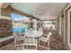 Covered patio with stone columns, ceiling fans, and ample seating near the community pool at 2344 Pleasant Hill Ln, Holiday, FL 34691