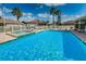 Community pool and jacuzzi with lounge chairs surrounded by a secure fence at 2344 Pleasant Hill Ln, Holiday, FL 34691
