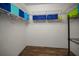 Spacious walk-in closet featuring wood-look flooring and wire shelving for optimal storage at 2344 Pleasant Hill Ln, Holiday, FL 34691