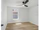 Cozy bedroom with vinyl flooring, a window, and a ceiling fan at 2415 E 20Th Ave, Tampa, FL 33605