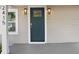 Close up of a light blue front door with the house number, sidelight and stylish sconces at 2415 E 20Th Ave, Tampa, FL 33605