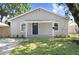 Charming single-story home featuring a well-maintained front lawn and inviting entrance at 2415 E 20Th Ave, Tampa, FL 33605