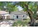 Inviting single-story home with a shady tree in the front yard offering curb appeal at 2415 E 20Th Ave, Tampa, FL 33605