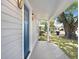 A welcoming front porch with a blue front door and fresh neutral colored siding at 2415 E 20Th Ave, Tampa, FL 33605