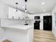 Updated kitchen features white cabinets, modern lighting, and stainless steel appliances at 2415 E 20Th Ave, Tampa, FL 33605
