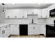 Renovated kitchen with white cabinets, sleek black hardware, and modern subway tile backsplash at 2415 E 20Th Ave, Tampa, FL 33605