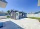 View of detached unit in backyard with concrete parking and exterior entry door at 2711 W Cordelia St, Tampa, FL 33607