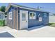 Close up of detached unit in backyard with concrete parking and exterior entry door at 2711 W Cordelia St, Tampa, FL 33607