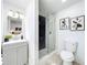 Modern bathroom featuring a glass enclosed shower with black marble tile and a gray vanity sink at 2711 W Cordelia St, Tampa, FL 33607