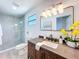Bright bathroom with a walk-in shower, a modern vanity with a dark wood finish, and stylish fixtures at 2711 W Cordelia St, Tampa, FL 33607