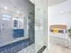Modern bathroom featuring a glass enclosed shower with gray and white marble tile that peeks into the bedroom at 2711 W Cordelia St, Tampa, FL 33607