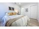 Bright bedroom with a queen size bed, light wood floors, and closet at 2711 W Cordelia St, Tampa, FL 33607