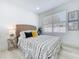 Bright bedroom with a woven headboard, patterned bedding, and bright natural light at 2711 W Cordelia St, Tampa, FL 33607