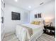 Bright bedroom with a queen size bed, light wood floors, and a barn door at 2711 W Cordelia St, Tampa, FL 33607