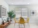 Dining area with a round white table, four yellow chairs, and a modern decor at 2711 W Cordelia St, Tampa, FL 33607