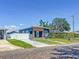 Cozy blue home with a modern wood accent, lush lawn, and charming brick street, blending comfort and style at 2711 W Cordelia St, Tampa, FL 33607