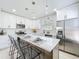 Bright kitchen features white cabinets, stainless appliances, and a large island with seating at 2711 W Cordelia St, Tampa, FL 33607