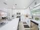 Modern kitchen with white cabinetry, stainless steel appliances, and a spacious island at 2711 W Cordelia St, Tampa, FL 33607