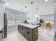 Open-concept kitchen featuring an island with a white countertop and gray cabinets at 2711 W Cordelia St, Tampa, FL 33607