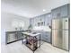 Charming kitchen with gray cabinetry, stainless appliances, and movable island at 2711 W Cordelia St, Tampa, FL 33607