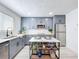 Charming kitchen with gray cabinetry, stainless appliances, and movable island at 2711 W Cordelia St, Tampa, FL 33607