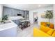 Bright living room with a kitchen view, gray cabinetry, stainless appliances, and movable island at 2711 W Cordelia St, Tampa, FL 33607