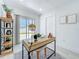 Bright office with a light wood desk, white walls, and a view to the backyard at 2711 W Cordelia St, Tampa, FL 33607