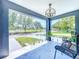 Stylish porch with clear glass enclosure, tiled floor, modern chairs, and view of the park at 2711 W Cordelia St, Tampa, FL 33607