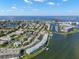 An aerial view displays a waterfront condo near beaches, nestled among residences and waterways at 280 126Th Ave # 106, Treasure Island, FL 33706