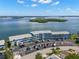 Aerial view capturing a waterfront condominium complex with ample parking and views of the surrounding waterways at 280 126Th Ave # 106, Treasure Island, FL 33706