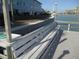 A charming bench situated along the waterfront dock, offering a serene spot to enjoy the picturesque views at 280 126Th Ave # 106, Treasure Island, FL 33706