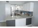 Stylish kitchen with modern white cabinetry, stainless steel appliances, and eye-catching pendant lighting, creating a chic space at 280 126Th Ave # 106, Treasure Island, FL 33706
