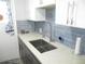 The kitchen sink is surrounded by elegant backsplash and countertops, offering a functional and stylish space at 280 126Th Ave # 106, Treasure Island, FL 33706