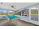 Bright game room features a billiard table, wood floors, and ample natural light from large windows at 3500 Gussie St, Punta Gorda, FL 33950